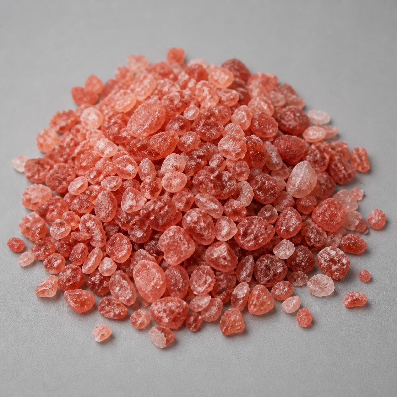 Deep pink coarse rock salt crystals.