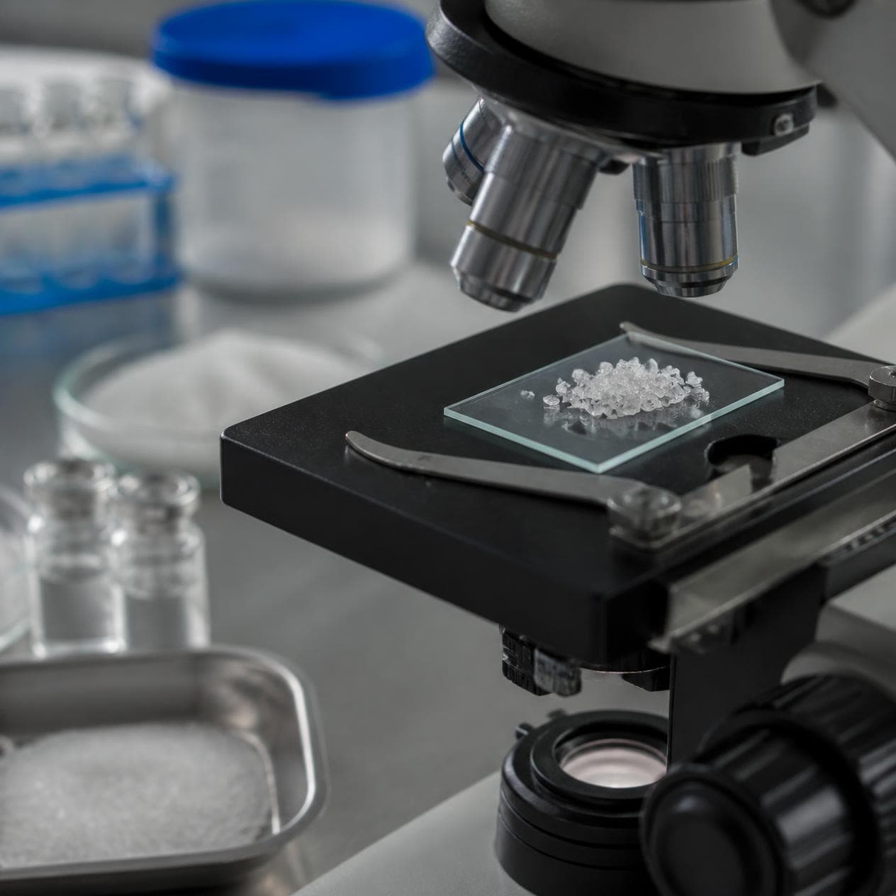 Salt samples being analysed with laboratory glassware.