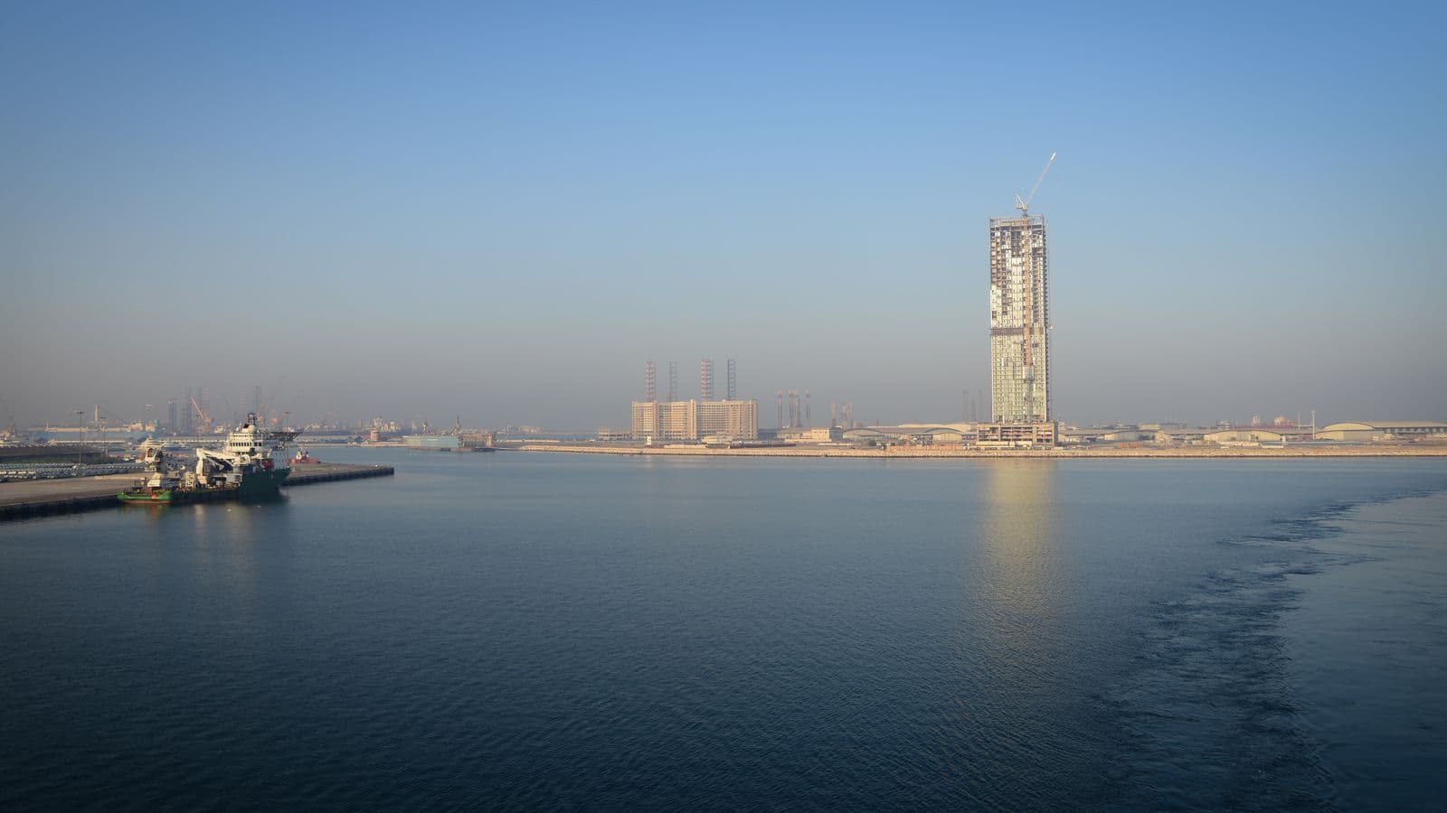 Harbour waterfront in the United Arab Emirates with a high-rise under construction.